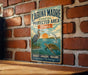 A vintage-style metal sign for the Laguna Madre Coastal Protected Area in Texas, featuring illustrations of birds, fish, and a sunset over the water.