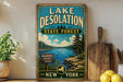 A vintage-style sign for Lake Desolation State Forest in New York, featuring a scenic landscape with a lake, pine trees, and mountains.