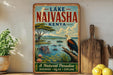 A vintage-style metal sign for Lake Naivasha, Kenya, featuring an illustration of a hippopotamus, a bird, and a scenic landscape.