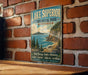 A vintage-style metal sign for Lake Superior Provincial Park in Ontario, featuring a scenic landscape with a mountain, lake, and forest.