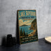 A vintage-style metal sign for Lake Superior Provincial Park, Ontario, featuring a scenic landscape with a mountain, lake, and pine trees.