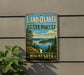 A vintage-style sign for the Land O'Lakes State Forest in Minnesota, featuring a scenic landscape with pine trees, a lake, and mountains.