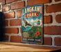 A vintage-style metal sign for Langkawi Park in Malaysia, featuring an illustration of a bird in flight, a cable car, and lush greenery.