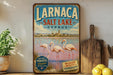 A vintage-style metal sign for Larnaca Salt Lake in Cyprus, featuring a scenic image of flamingos in the water.