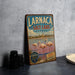 A vintage-style metal sign for Larnaca Salt Lake, Cyprus, featuring a scenic image of flamingos in the water.
