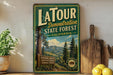 A vintage-style metal sign for Latour State Forest, California, featuring a scenic image of a forest and mountains.