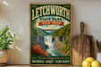 A vintage-style sign for Litchworth State Park, New York, featuring a scenic waterfall and lush greenery.