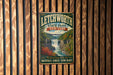 A vintage metal sign for Litchworth State Park in New York, featuring a scenic waterfall and lush greenery.