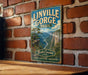 A vintage-style metal sign for Linville Gorge Trail, featuring a scenic mountain landscape with a river, mounted on a brick wall.