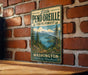 A vintage-style metal sign for Little Pend Oreille State Forest in Washington, featuring a scenic landscape with pine trees, mountains, and a lake.