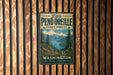 A vintage metal sign for Little Pend Oreille State Forest in Washington, featuring a scenic mountain landscape with pine trees and a lake.