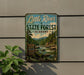 A vintage-style metal sign for Little River State Forest in Alabama, featuring a scenic image of a river surrounded by trees and mountains.