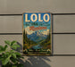 A vintage-style metal sign for the Lolo National Forest in Montana, featuring a scenic mountain landscape with pine trees and a river.