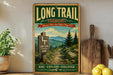 A vintage-style sign for the Long Trail in Vermont, featuring a scenic mountain landscape with a trail marker and the text "Long Trail Vermont" and "America's Oldest Long Distance Hiking Trail!".