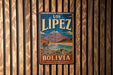 A vintage metal sign with the text "LOS LIPEZ BOLIVIA" and an illustration of a llama standing in front of a mountain.