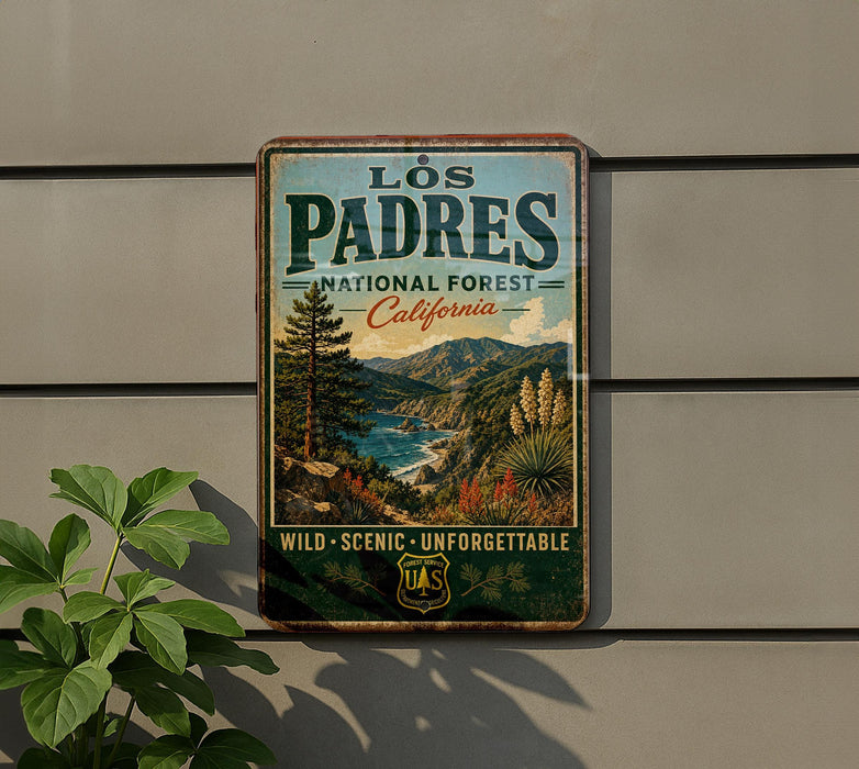 A vintage-style metal sign for the Los Padres National Forest in California, featuring a scenic landscape with mountains, trees, and a river.