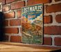 A vintage-style sign for Lost Maple State Natural Area in Texas, featuring a scenic landscape with a river and autumn foliage.