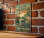 a vintage metal sign with a tropical landscape and wildlife, hanging on a brick wall.