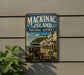 A vintage metal sign for Mackinac Island Historic District, featuring an illustration of a horse-drawn carriage and buildings along a waterfront.