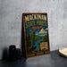 A vintage metal sign for Mackinaw State Forest, Michigan, featuring a scenic landscape with a moose and a river.