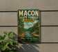 A vintage metal sign for the Macon State Forest in Alabama, featuring a scenic landscape with a river and trees.