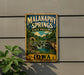 A vintage-style metal sign for Malanaphy Springs State preserve, featuring a scenic landscape with a waterfall and a bridge.