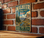 A vintage metal sign for Malheur National Forest in Oregon, featuring a scenic landscape with mountains, trees, and a river.