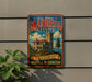 A vintage-style metal sign for the Manresa Castle, featuring an illustration of the castle and a banner that reads "A Touch of Old World Elegance on the Washington Coast".