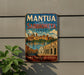 A vintage metal sign with the text "MANTA AND SABBIONETA ITALY" and an illustration of a cityscape, with the text "TWO TIMELESS CITIES" below it.