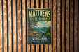 A vintage metal sign for Matthews State Forest in Virginia, featuring a scenic landscape with pine trees and a river.