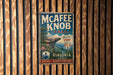 A vintage-style metal sign for the Mcafee Knob Trail in Virginia, featuring a scenic mountain landscape and encouraging visitors to "Take in the View, Keep it Wild!"