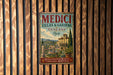 a vintage metal sign advertising "MEDICI VILLAS & GARDENS TUSCANY ITALY" with a scenic illustration of a garden and a building.