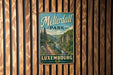 A vintage metal sign for "Meisterdall Park" in Luxembourg, featuring a scenic mountain landscape.