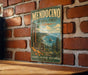 A vintage-style metal sign for Mendocino National Forest in California, featuring a scenic illustration of the forest and coastline.