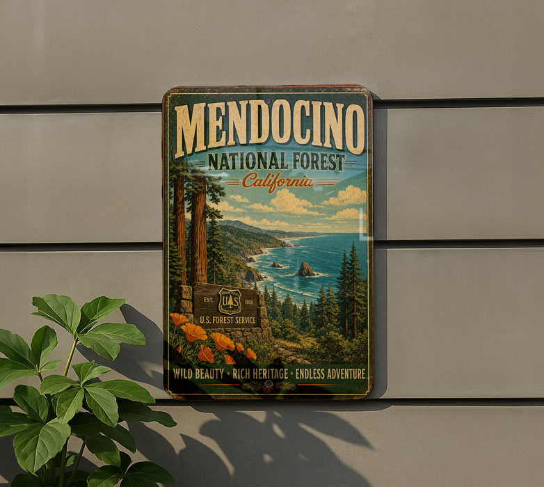 A vintage-style metal sign for Mendocino National Forest in California, featuring a scenic landscape with pine trees, mountains, and a body of water.
