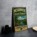 A vintage-style metal sign for the Mesomorphic State Forest in Connecticut, featuring a scenic landscape with a river and pine trees.