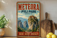 A vintage-style metal sign for Meteora, Pyli Park, Greece, featuring a mountainous landscape with a castle-like structure on a cliff.