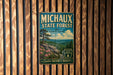A vintage-style poster for the Michaux State Forest in Pennsylvania, featuring a scenic landscape with pine trees, mountains, and a river.