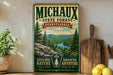 A vintage-style poster advertising the Michaux State Forest in Pennsylvania, featuring a scenic mountain landscape with pine trees and a river.