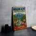 A vintage-style metal sign for the Minami- Alps Biosphere Reserve in Japan, featuring a mountain landscape with a bird perched on a rock.