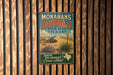 A vintage metal sign for Monahans Sandhills State Park in Texas, featuring a desert landscape with a palm tree and other desert plants.