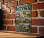 a vintage-style metal sign with illustrations of Greek temples and a brick wall backdrop.