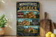 a vintage-style metal sign with illustrations of Greek monasteries, placed on a wooden surface next to a wooden cutting board and some lemons.