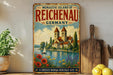 A vintage-style metal sign for the Monastice Island of Reichenau, Germany, featuring a castle, river, and flowers.
