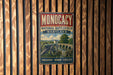 A vintage metal sign with the text "MONOCACY NATIONAL BATTLEFIELD MARYLAND" and an illustration of a cannon and a bridge, mounted on a wooden wall.