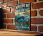 A vintage metal sign for Monterey Bay National Marine Sanctuary, featuring an illustration of marine life and the text "California" and "Explore + Protect + Inspire".