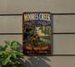 A vintage metal sign for Moore's Creek National Battlefield, featuring a historical battle scene with soldiers and a river.