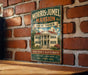 A vintage-style metal sign for the Morris-Jamel mansion in New York, featuring an illustration of the mansion and text indicating its historical significance.