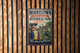 A vintage-style metal sign for Morristown National Historical Park in New Jersey, featuring an illustration of a man in military uniform and a cannon.