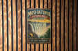 A vintage-style metal sign for Mosi-Oa-Tunya Victoria Falls, Africa, featuring a waterfall and a rainbow.